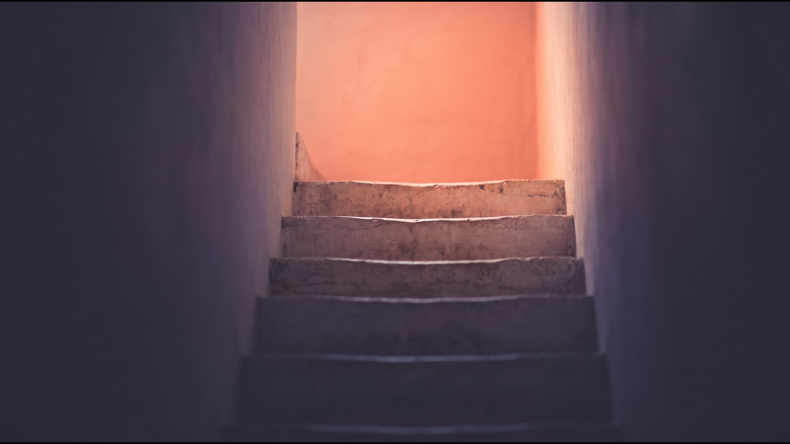 Shallow pale steps rising in soft daylight toward warm light